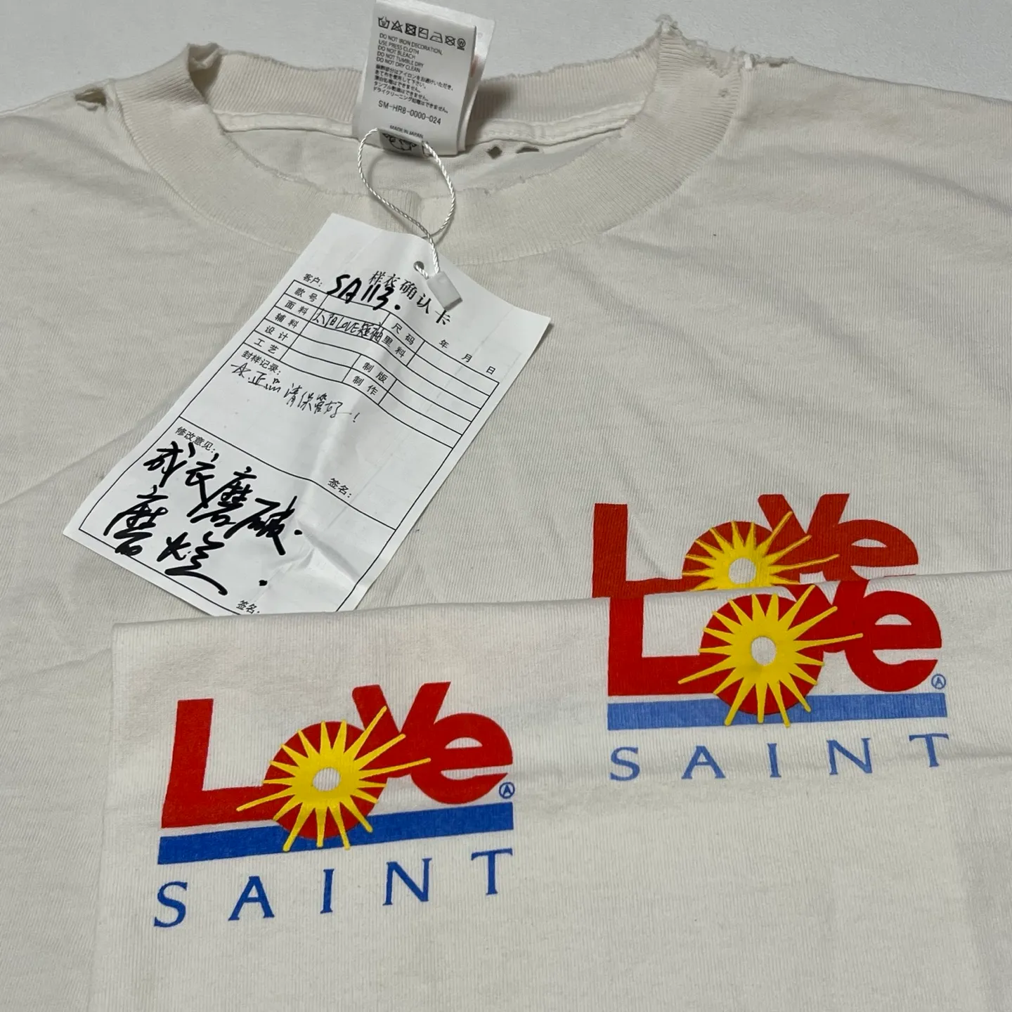 Printing and proofing comparison SAINT Mxxxxxx 25SS LOVE_SS TEE/WHT LOVE little sun damaged washed distressed short sleeves off-white S-XL rainbow OE yarn original consistent tube woven side seam fabric re-washed distressed process cut and destroyed holes processing hand-made graffiti splash ink original consistent main mark/wash mark/little angel anti-counterfeiting mark